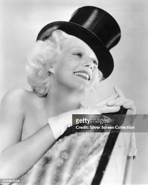American actress Jean Harlow wearing a top hat in a promotional portrait for 'Bombshell', directed by directed by Victor Fleming, 1933.