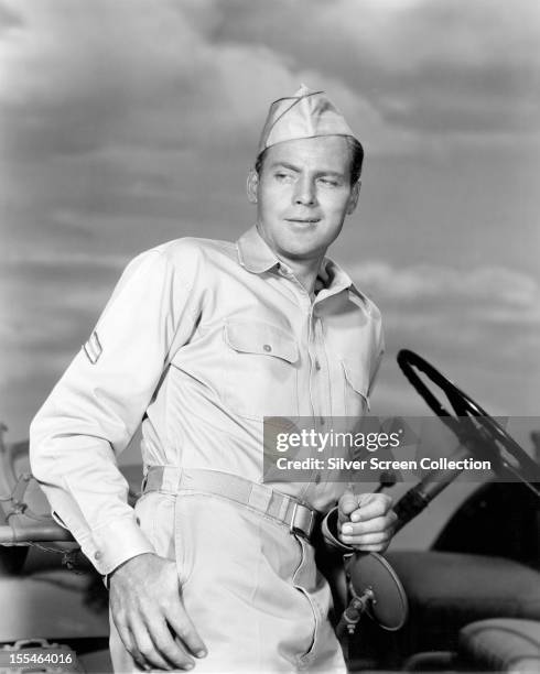 American actor John Agar as Sergeant Dick Mason in 'Joe Butterfly', directed by Jesse Hibbs, 1957.