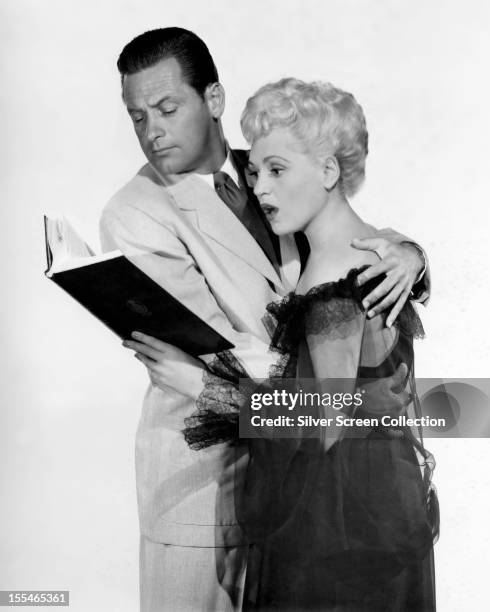 American actor William Holden as Paul Verrall, and American actress Judy Holliday as Emma 'Billie' Dawn, in 'Born Yesterday', directed by George...