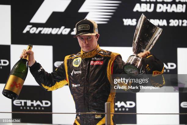 Kimi Raikkonen of Finland and Lotus celebrates on the podium after winning the Abu Dhabi Formula One Grand Prix at the Yas Marina Circuit on November...