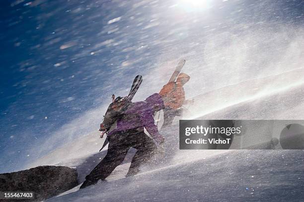 two back country riders breaking a trail upwards - blizzard stock pictures, royalty-free photos & images