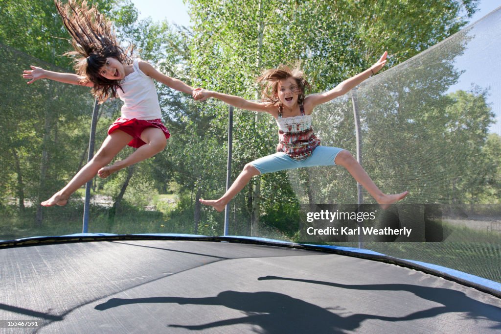 Sisters jumping on a trampoline