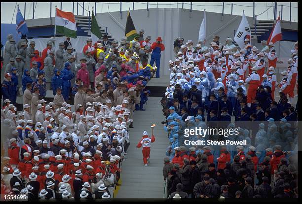 TWELVE YEAR OLD ROBYN PERRY CARRIES THE OLYMPIC TORCH UP THE STEPS TO WHERE THE OLYMPIC FLAME WILL BE LIT DURING THE OPENING CEREMONY OF THE 1988...