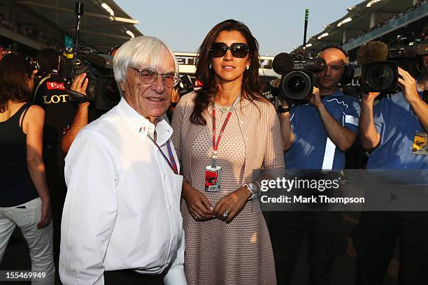 Supremo Bernie Ecclestone and his wife Fabiana Flosi are seen on the grid before the Abu Dhabi Formula One Grand Prix at the Yas Marina Circuit on...