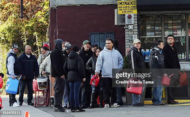 People wait on line on East Houston Street in Lower Manhattan following Superstorm Sandy on November 4, 2012 in New York City. The wait time was only...