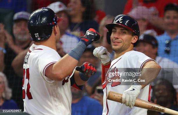 Austin Riley of the Atlanta Braves reacts with Matt Olson after hitting a three-run homer in the fourth inning against the Arizona Diamondbacks at...