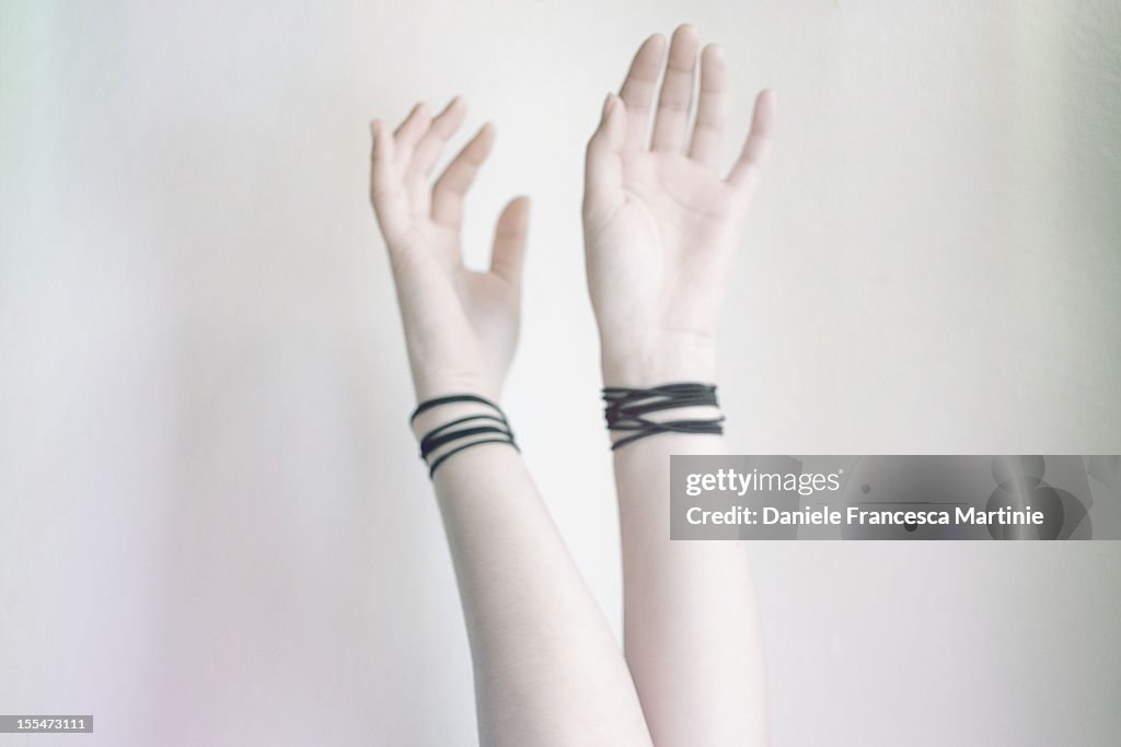 Pale hands and black bands