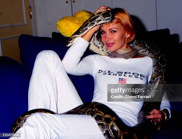 The French actress and dancer Marlene Mourreau at home with her pet, a snake, 25th November 1999, Madrid, Castilla La Mancha, Spain. .