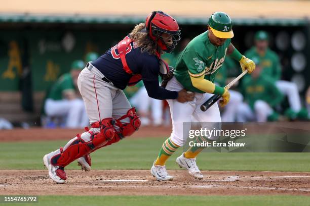 Jorge Alfaro of the Boston Red Sox tags out Jordan Diaz of the Oakland Athletics for a strike out in the second inning at RingCentral Coliseum on...