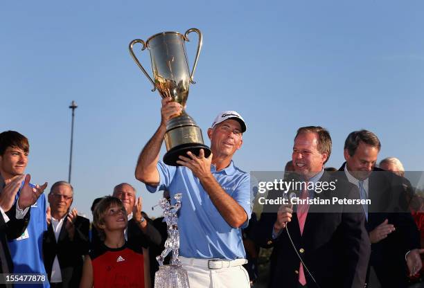 Tom Lehman hoists the Schwab Cup after winning the Charles Schwab Cup Championship on the Cochise Course at The Desert Mountain Club on November 4,...