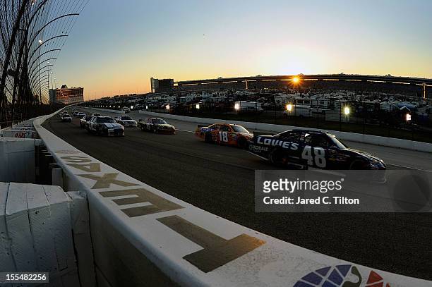Jimmie Johnson, driver of the Lowe's Chevrolet, leads the field down the backstretch during the NASCAR Sprint Cup Series AAA Texas 500 at Texas Motor...