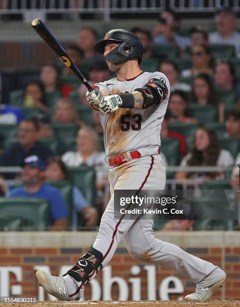Christian Walker of the Arizona Diamondbacks hits a three-run homer in the sixth inning against the Atlanta Braves at Truist Park on July 18, 2023 in...