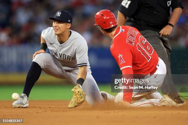 Mickey Moniak of the Los Angeles Angels steals second base as Anthony Volpe of the New York Yankees is unable to place the tag during the fifth...