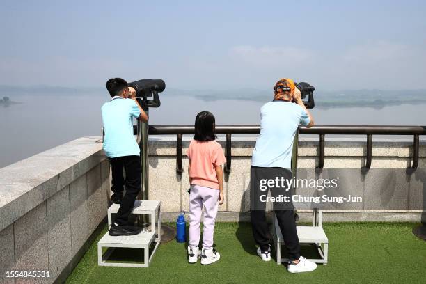 Tourists look over North Korea at the Unification Observation Platform, near the demilitarized zone on July 19, 2023 in Paju, South Korea. A U.S....