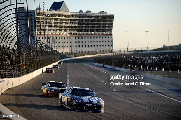 Jimmie Johnson, driver of the Lowe's Chevrolet, leads Jeff Gordon, driver of the Drive to End Hunger Chevrolet, down the backstretch during the...