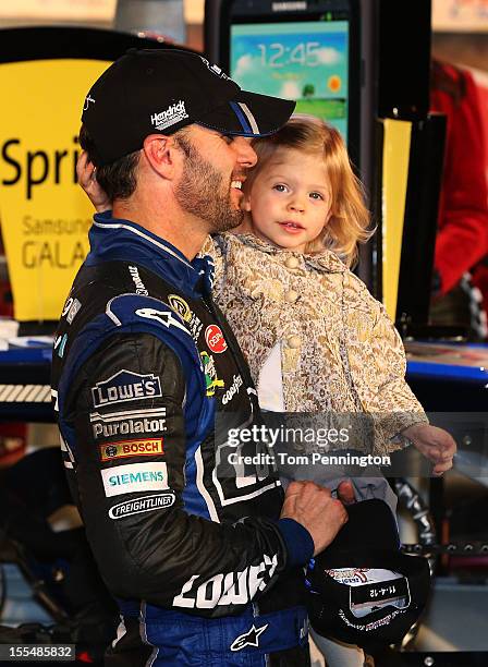 Jimmie Johnson, driver of the Lowe's Chevrolet, celebrates in Victory Lane with daughter Genevieve Marie after winning the NASCAR Sprint Cup Series...