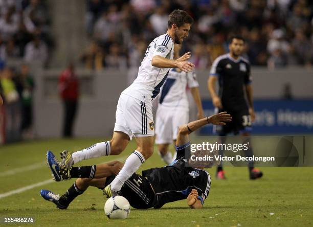 Tommy Meyer of the Los Angeles Galaxy and Steven Lenhart of the San Jose Earthquakes clash near the touchline in the first half during the first leg...