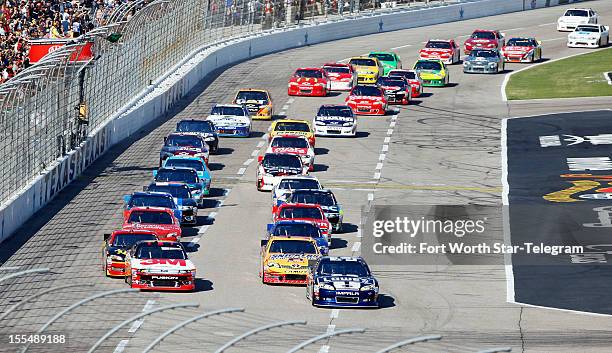 Jimmie Johnson, in the No. 48 car, leads the pack at the start during the NASCAR Sprint Cup, AAA Texas 500 at Texas Motor Speedway in Fort Worth,...