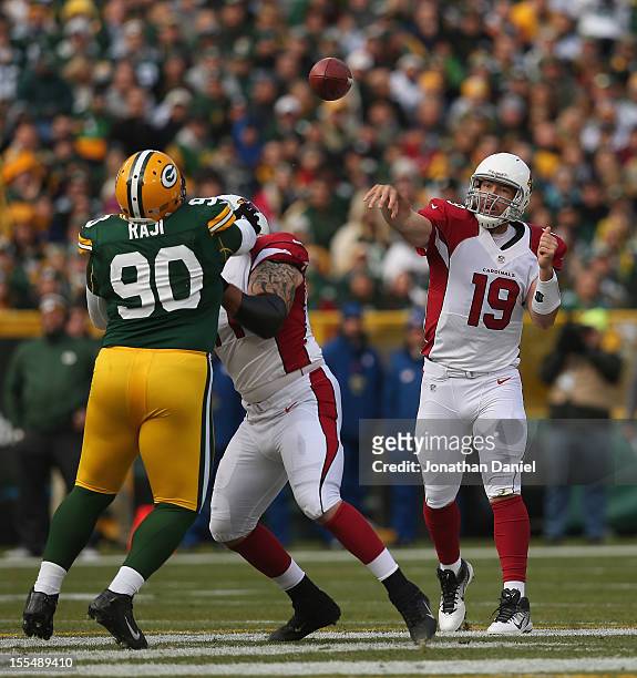 John Skelton of the Arizona Cardinals passes as Daryn Colledge blocks B.J. Raji of the Green Bay Packers at Lambeau Field on November 4, 2012 in...