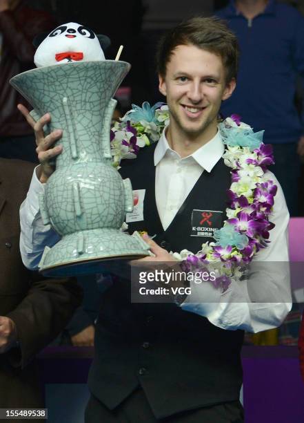Judd Trump of England celebrates with the winners trophy after his match against Neil Robertson of Australia on day eight of the 2012 World Snooker...