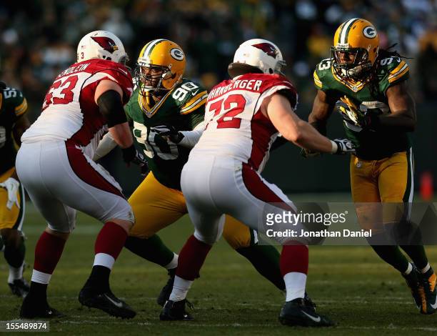 Raji and Erik Walden of the Green Bay Packers rush against Lyle Sendlein and Rich Ohrnberger of the Arizona Cardinals at Lambeau Field on November 4,...