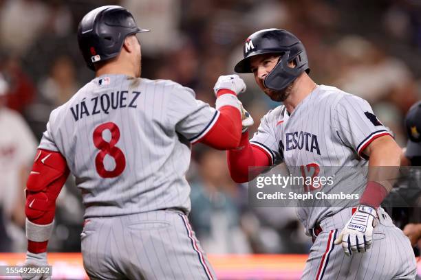 Kyle Farmer of the Minnesota Twins celebrates his home run with Christian Vazquez during the ninth inning against the Seattle Mariners at T-Mobile...