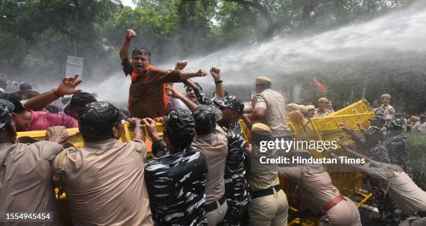 Security personnel use water cannon to disperse Bharatiya Janata Party workers during a protest against Delhi Chief Minister and AAP Convenor Arvind...