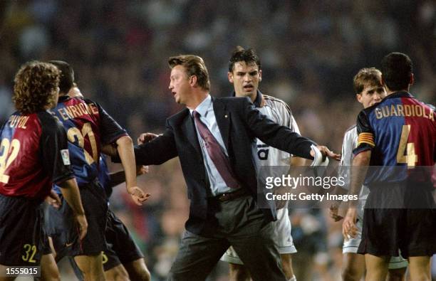 Barcelona coach Louis van Gaal calms his players down against Real Madrid during the Spanish Primera Liga match at the Nou Camp in Barcelona, Spain....