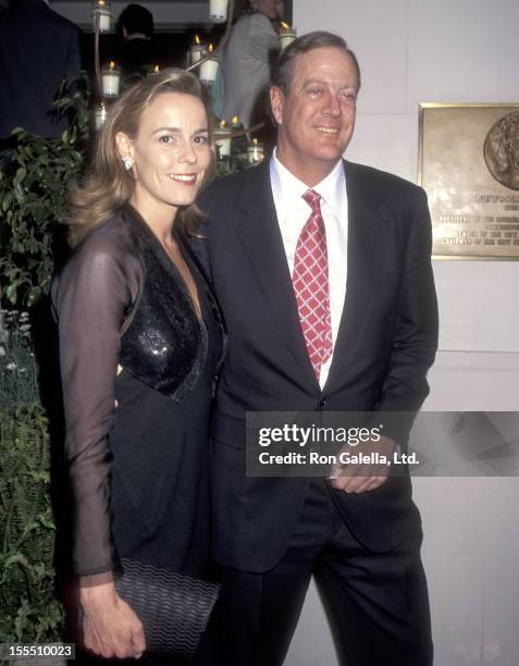 Businessman David H. Koch and guest Julia Flesher attend An Evening of Fashion by Celine - Benefit for Gods Love We Deliver on May 23, 1995 at City...
