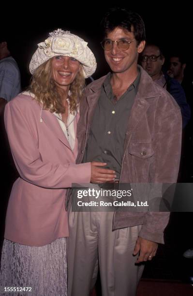 Actor Robert Carradine and wife Edie Mani attending the premiere of Point Break on July 10, 1991 at Avco Cinema Center in Westwood, California.