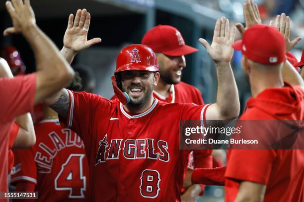 Mike Moustakas of the Los Angeles Angels celebrates after scoring from second base on a double by Mickey Moniak to take a 7-6 lead over the Detroit...