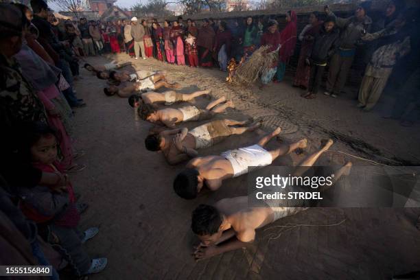 Nepalese Hindu devotees offer prayers by rolling on the ground after performing a bathing ritual on the last day of the month-long Swasthani Festival...