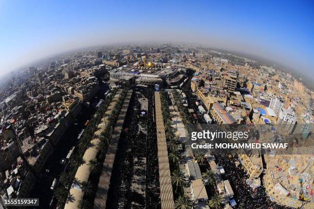 An aerial view taken with a fish-eye lens shows Shiite Muslims flocking to the shrine of Imam Hussein, on January 14, 2012 during the religious...