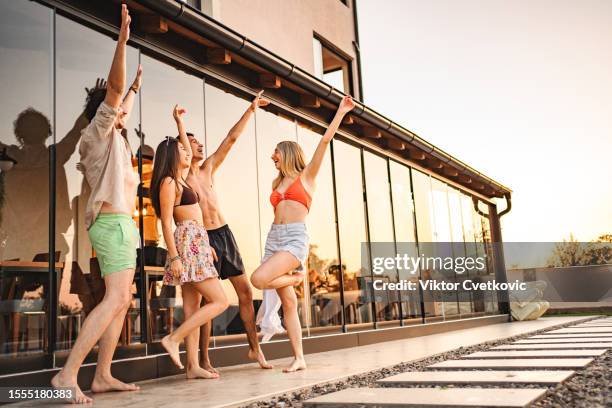 small group of friends having fun near the swimming pool - 20 years old dancing stock pictures, royalty-free photos & images