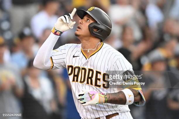 Manny Machado of the San Diego Padres points skyward after hitting a solo home run during the second inning of a baseball game against the Pittsburgh...