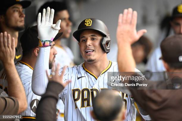 Manny Machado of the San Diego Padres in congratulated after hitting a solo home run during the second inning of a baseball game against the...