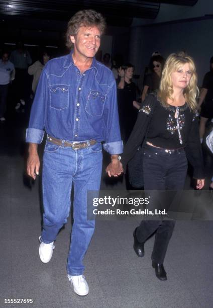 Musician John Fogerty and wife Julie Lebiedzinski on June 9, 1997 arrive at the Los Angeles International Airport in Los Angeles, California.