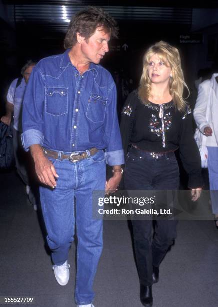 Musician John Fogerty and wife Julie Lebiedzinski on June 9, 1997 arrive at the Los Angeles International Airport in Los Angeles, California.