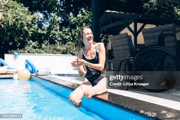 happy disabled woman spends time at the pool. - disability choicepix stock pictures, royalty-free photos & images