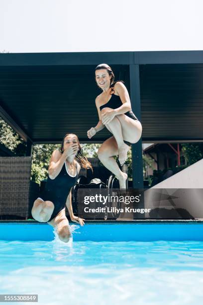 two girlfriends spend time at the pool. - disability choicepix stock pictures, royalty-free photos & images
