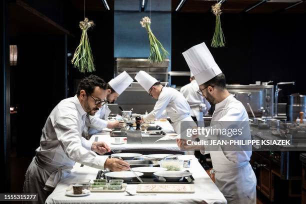 Michelin three-star chef Cesar Troisgros cooks at his hotel-restaurant "Le Bois sans Feuilles" in Ouches on June 9, 2023. At the age of 36, Cesar...