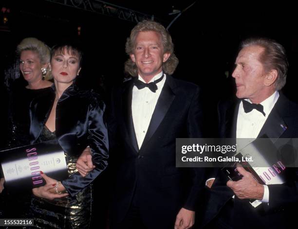 Actor Kirk Douglas and Peter Douglas attend the premiere of Scrooged on November 17, 1988 at Mann Chinese Theater in Hollywood, California.