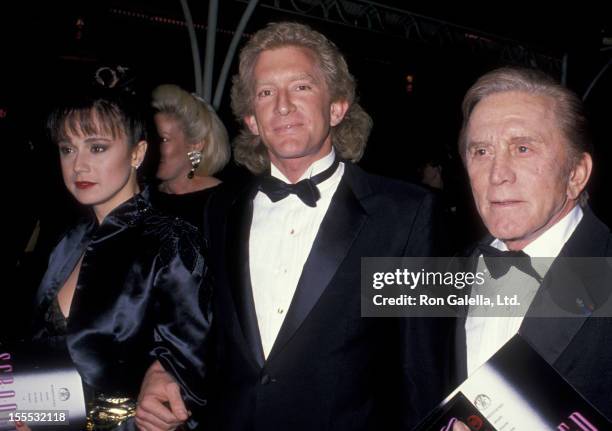 Actor Kirk Douglas and Peter Douglas attend the premiere of Scrooged on November 17, 1988 at Mann Chinese Theater in Hollywood, California.