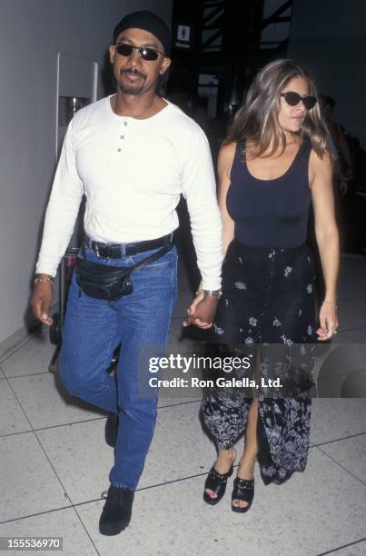 Talk Show Host Montel Williams and wife Grace Morley being photographed on June 25, 1997 at the Los Angeles International Airport in Los Angeles,...