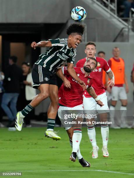 Shola Shoretire of Manchester United heads the ball against Elliot Lee of Wrexham during the first half of their pre-season friendly at Snapdragon...