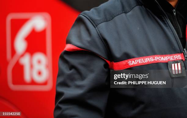 Picture taken on November 4, 2012 shows a firefighter wearing his uniform in a firehouse in Boulogne-sur-Mer, in northern France. AFP PHOTO PHILIPPE...