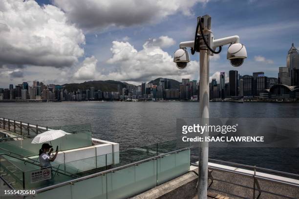 This photo taken on June 29, 2023 shows closed circuit television cameras on a promenade next to Victoria Harbour in Hong Kong. After massive and at...