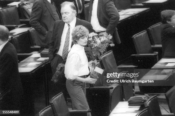 Petra Kelly with flowers in the plenary chamber of the Federal German Parliament on March 29, 1983 in Bonn, Germany. The Greens, moving in the...