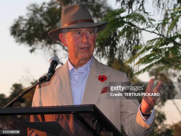 Britain's Prince Charles speaks to guests at a garden barbeque with locals after the royal couple arrived at Longreach in outback Queensland on...