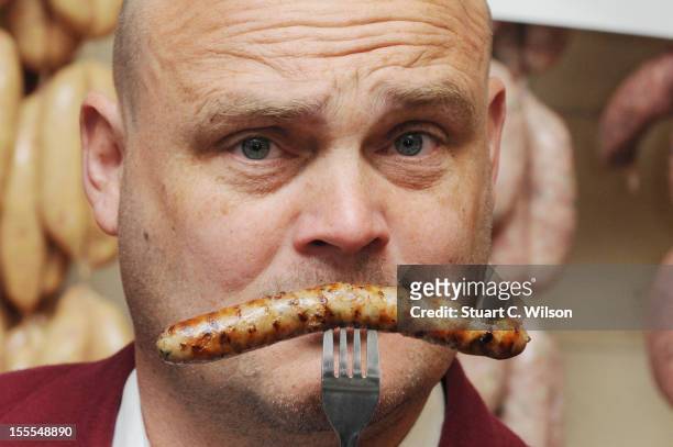 Al Murray attends a photocall to launch British Sausage Week at Allen's of Mayfair, London's oldest butcher shop on November 5, 2012 in London,...